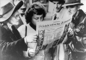 Bild: Süddeutsche Zeitung, Interessierte Zeitungsleser nach der Urteilsverkündung der Nürnberger Prozesse, 1. Oktober 1945
